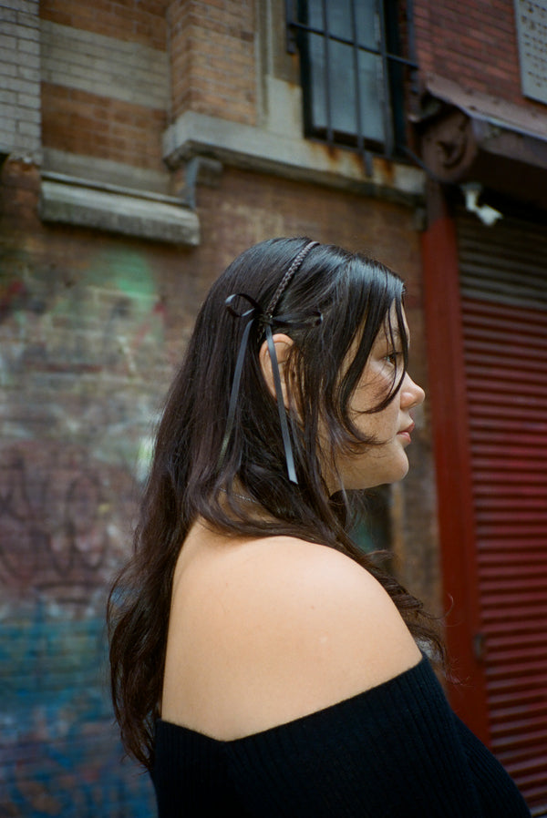 Brown headband with braided detail and bows on either side