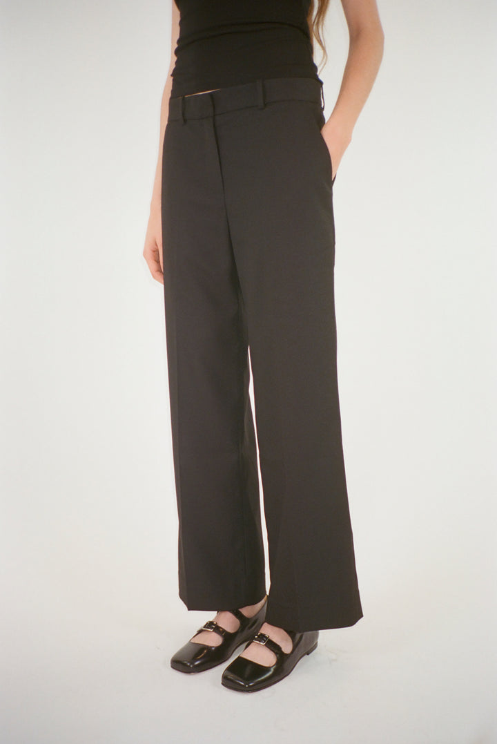 Cropped trouser in black suiting fabric on model