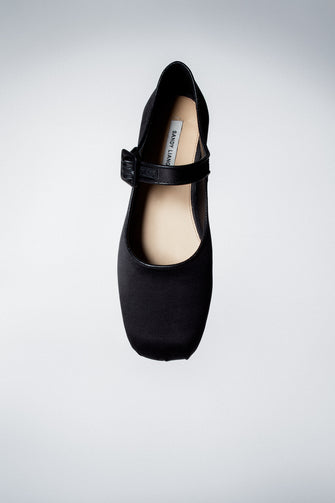 Top view of a Mary Jane Pointe ballet flat shoe in black satin against a white backgrund