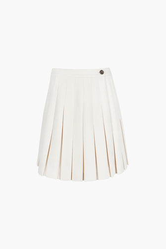 Pleated knee length skort in a bone color with built-in shorts, fully lined against a white background