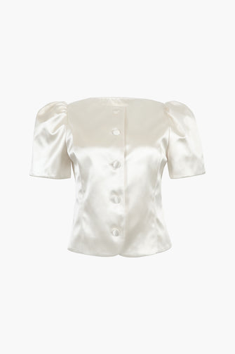 A tailored champagne satin jacket with short puff sleeves and tonal button closures on a white background.