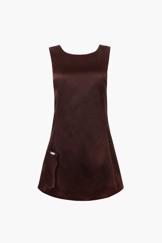 Brown dress with mini dress attached photographed on a white background