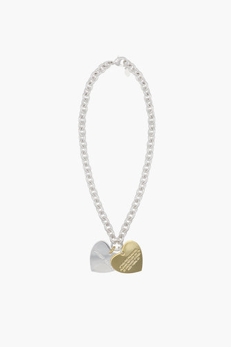 Necklace with heart-shaped gold and silver charms on a white background