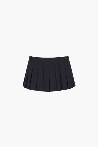 A pleated dark navy micro skort with built-in shorts and a button closure at the side against a white background.