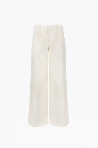 Full length cotton trousers in cream color, wide leg fit, and low waist against a white background