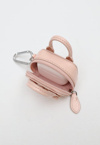 Pink leather bag keychain with carabiner on a white background with headphone case inside