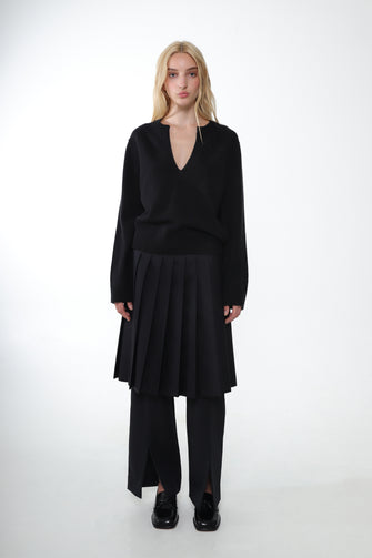 Person wearing a black outfit on a white background