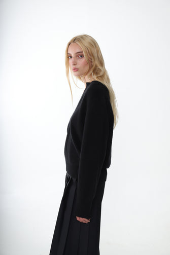 Woman wearing a black dress against a white background