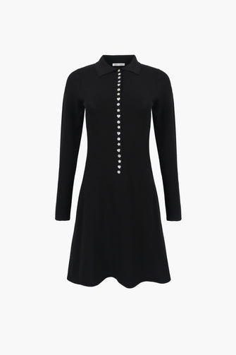 Black dress with button details on a white background