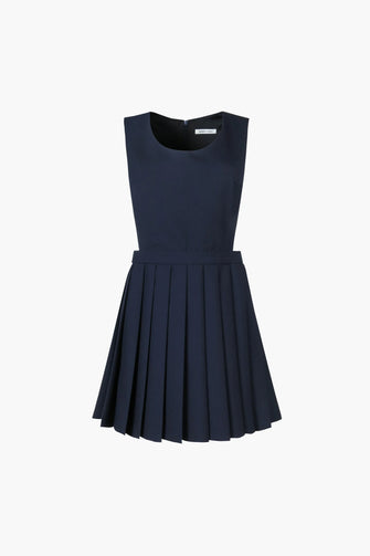 Mini pleated navy pinafore dress with a scooped neckline, concealed zipper at back, and is fully lined against a white background