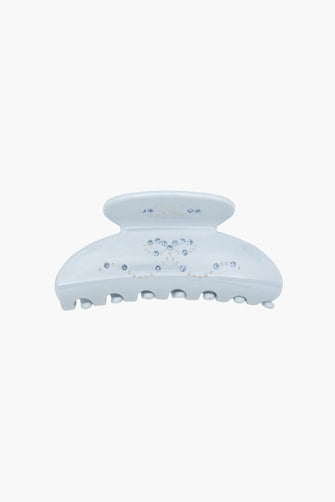 Blue hair claw clip with blue rhinestone details on a white background