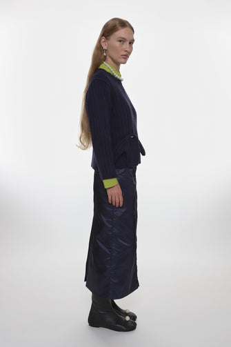 Person wearing a dark blue outfit with a white background