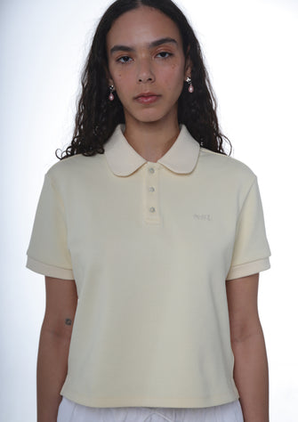 A person wearing a yellow polo shirt with a collar, short sleeves, and button-up front.