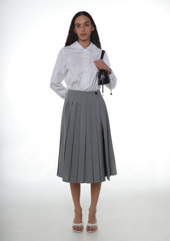A pleated midi length skort in grey with built-in shorts, fully lined, displayed on a model.