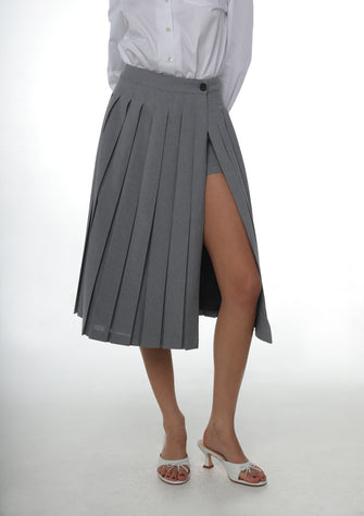 A pleated midi length skort in grey with built-in shorts, fully lined, displayed on a model.