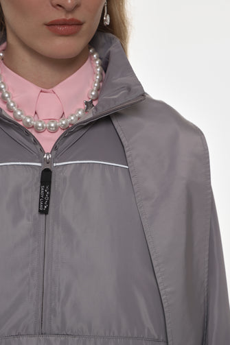 model wearing grey jacket and floral skirt