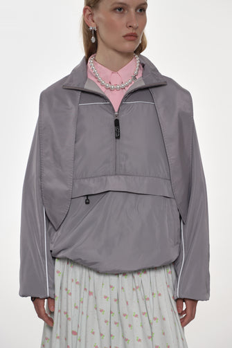 model wearing grey jacket and floral skirt