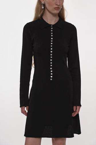Black dress with pearl buttons on a white background