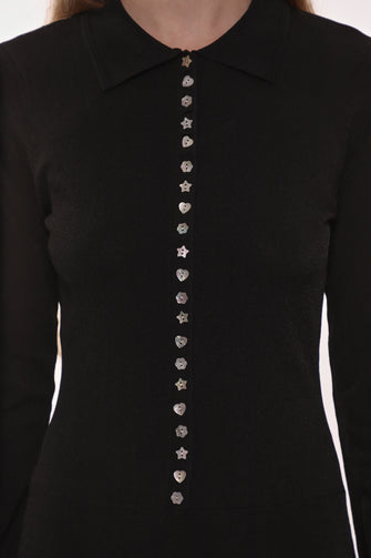 Black dress with decorative buttons on a white background