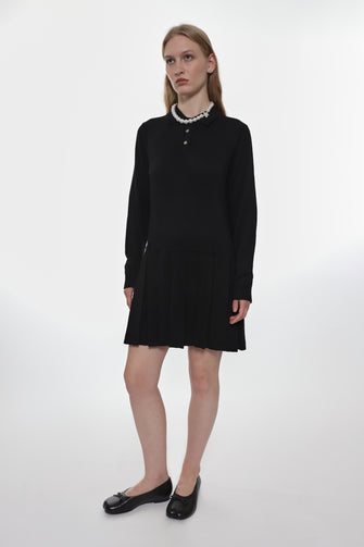 model wearing black dress and black leather ballerina flats
