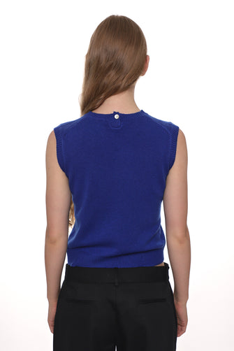 Person wearing a blue sleeveless top on a white background