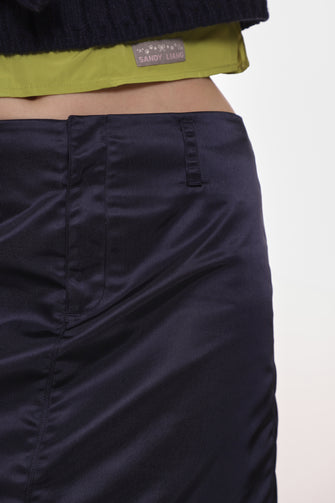 Close up navy blue mid length nylon skirt product image on a model