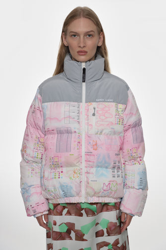 Person wearing a colorful patchwork jacket with a white background