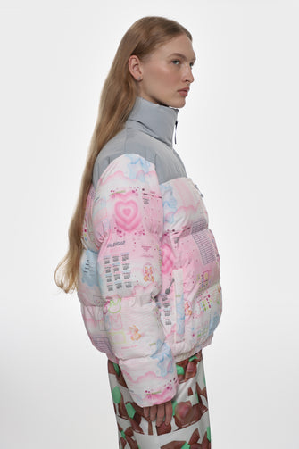 Person wearing a colorful, patterned puffer jacket on a white background