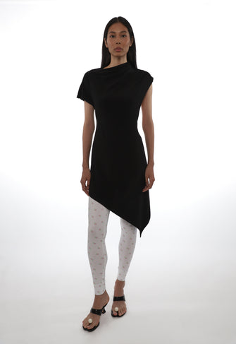 Woman wearing a black dress with an asymmetrical hem on a white background