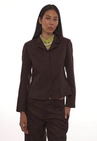 Woman wearing a brown suit with a white background