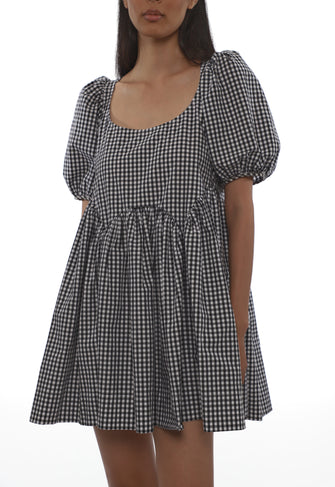 Black and white checkered babydoll dress with puff sleeves on a white background