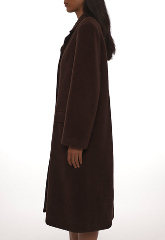 Brown coat worn by a person on a white background
