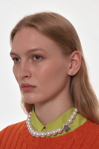 model wearing small star earring