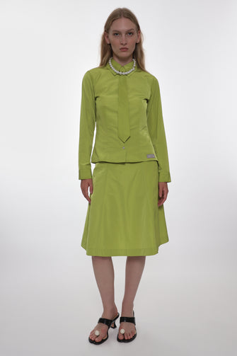 Woman wearing a green outfit on a white background