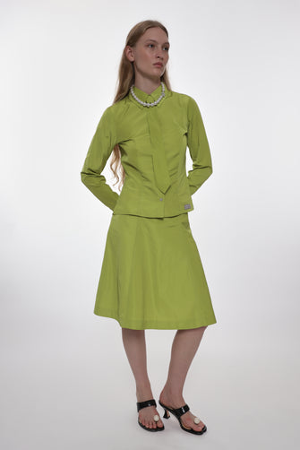 Woman wearing a green outfit with a white background