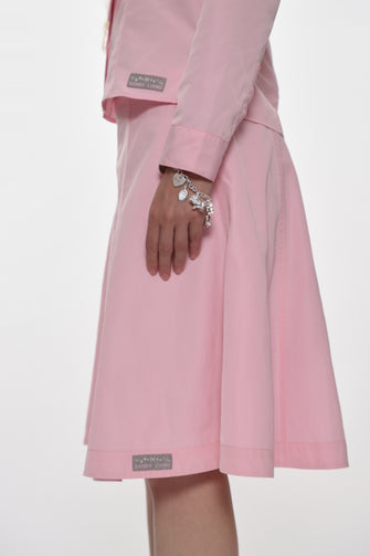 Pink outfit with matching skirt and top on a white background