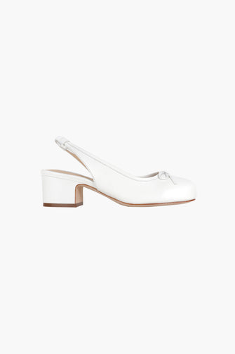 A white Nappa leather slingback shoe with a padded leather footbed, elasticated ankle strap, and a 45mm stacked leather heel against a white background
