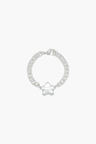 A silver cable chain bracelet with a star tag pendant against a white background.