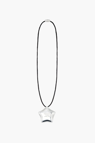 Star-shaped pendant on a black cord against a white background