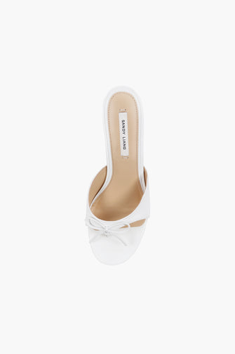 A top view of a single optic white nappa leather thong mule with a padded leather footbed and a 60mm heel against a white background