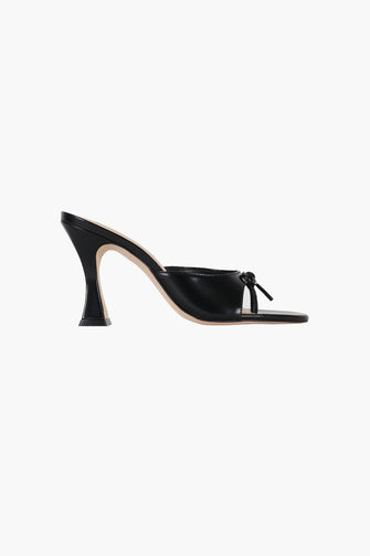 A side view of a black spazzolato leather thong mule with a padded leather footbed and a 90mm heel against a white background