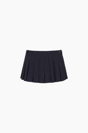 A pleated dark navy micro skort with built-in shorts and a button closure at the side on a white background