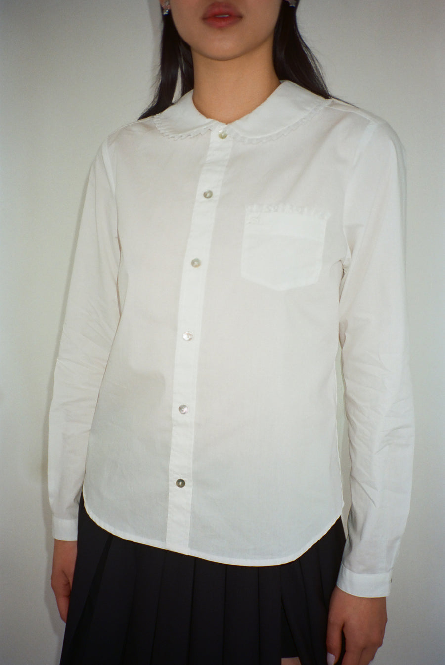 Long sleeve button up collared shirt with lace detail in white on model