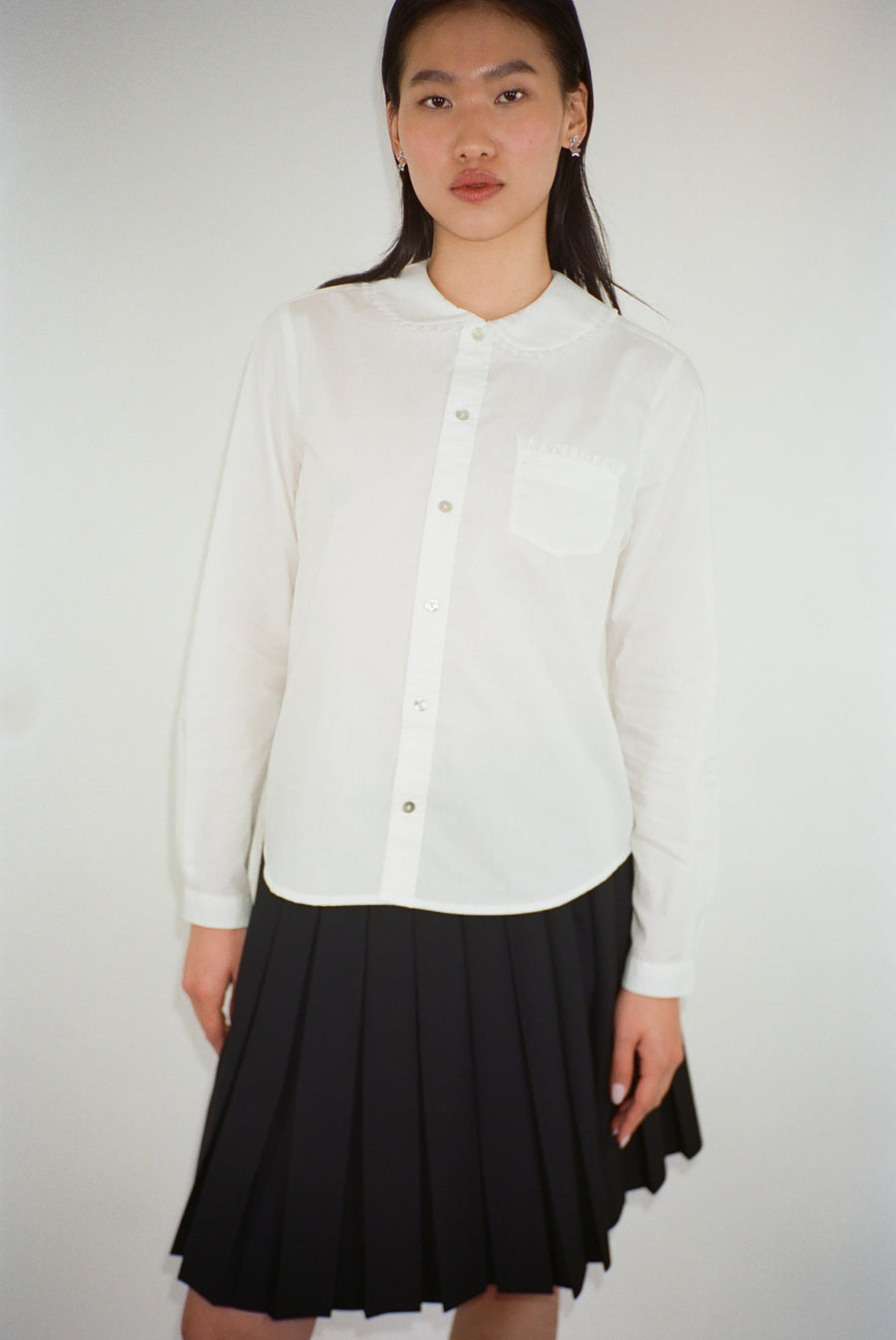 Long sleeve button up collared shirt with lace detail in white on model