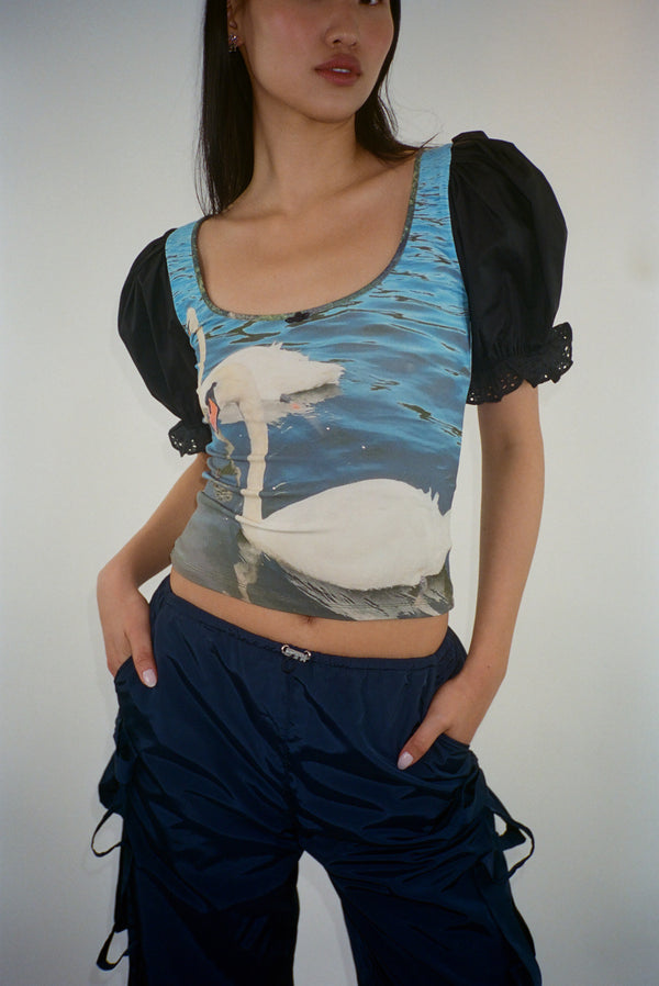 Short sleeved top featuring a pair of swans with puffed sleeves