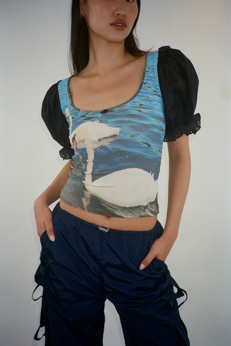 Short sleeved top featuring a pair of swans with puffed sleeves on model