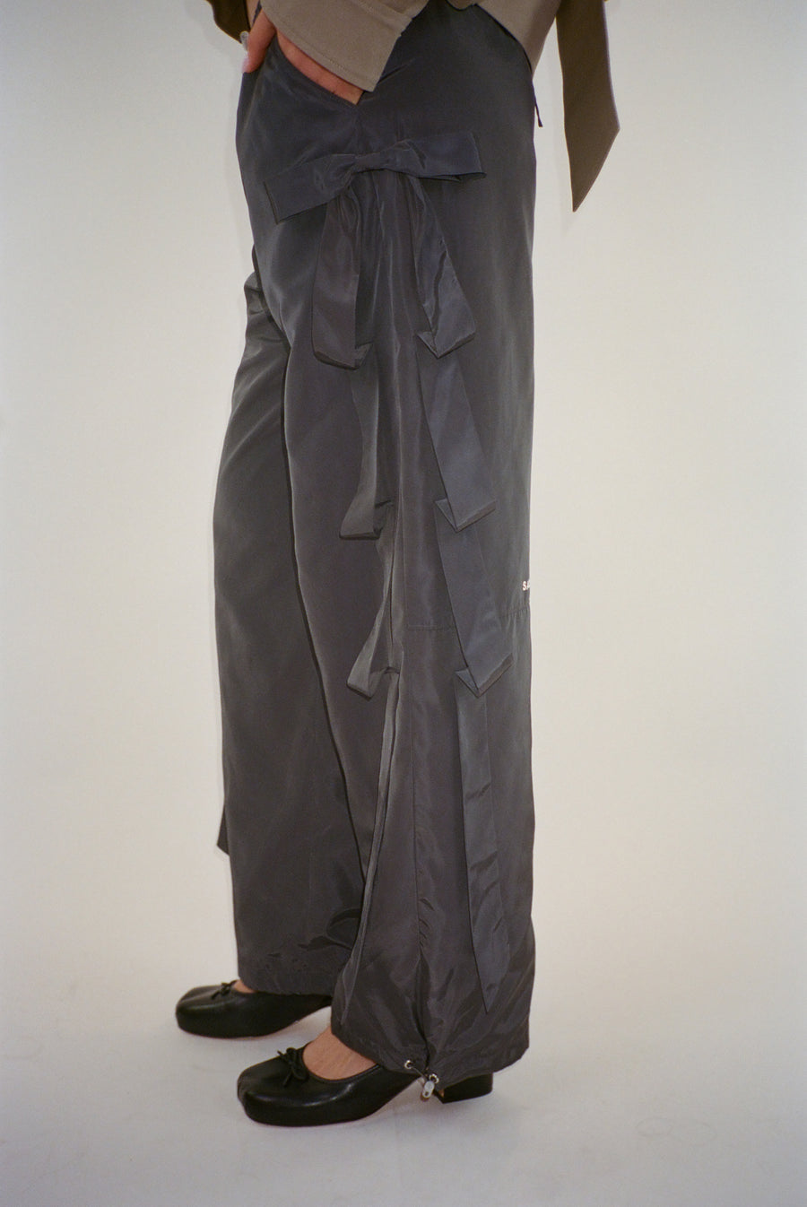 Trackpant in charcoal with tacked bow detail at sides on model