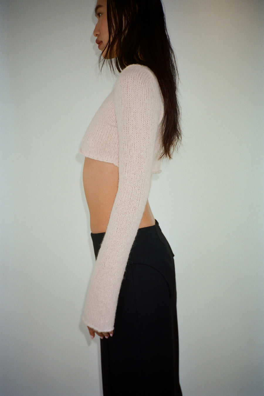 Cropped knit sweater in blush pink on model