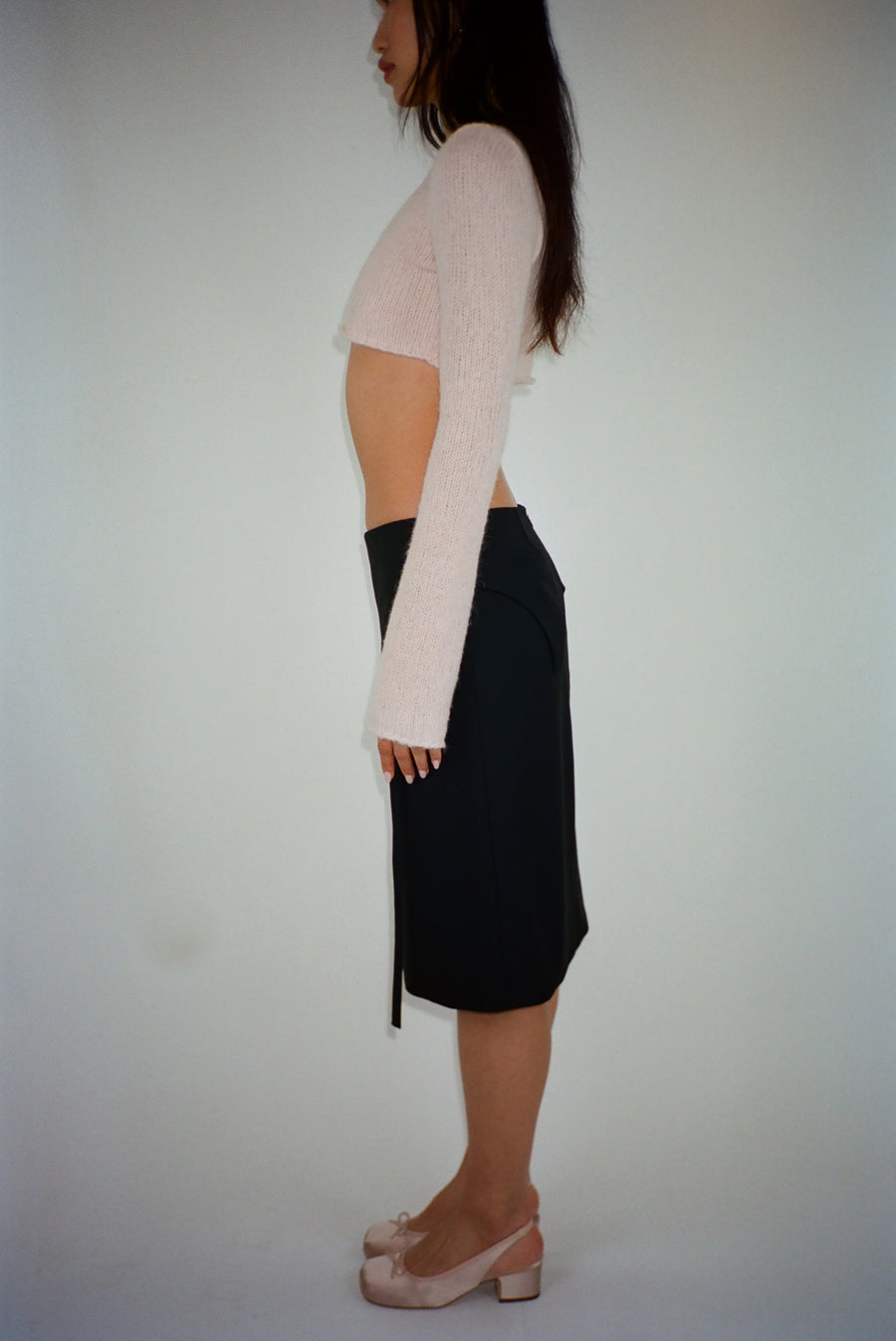 Knee length skirt in black with garter strap detail on model