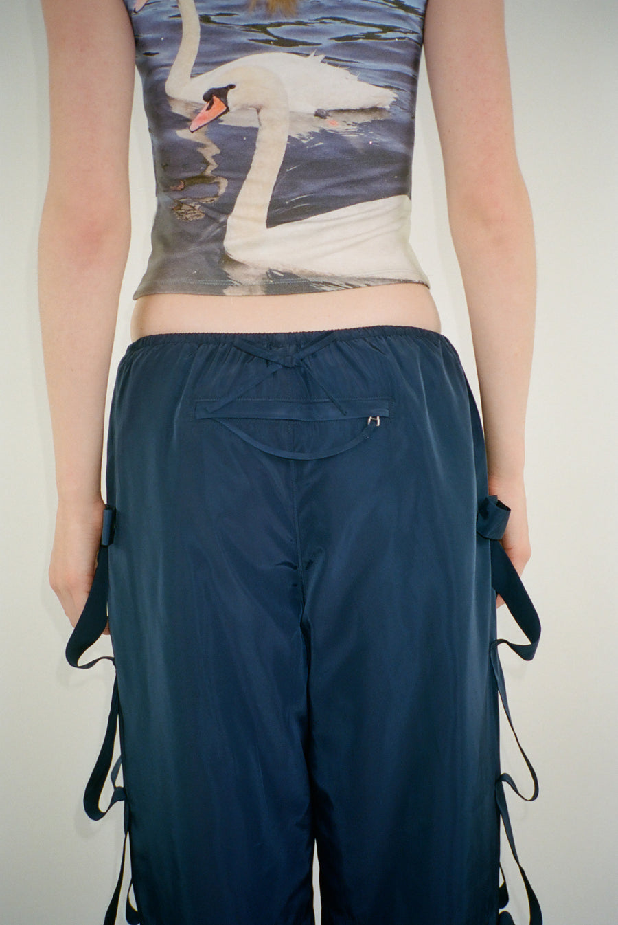 Trackpant in navy with tacked bow detail at sides on model